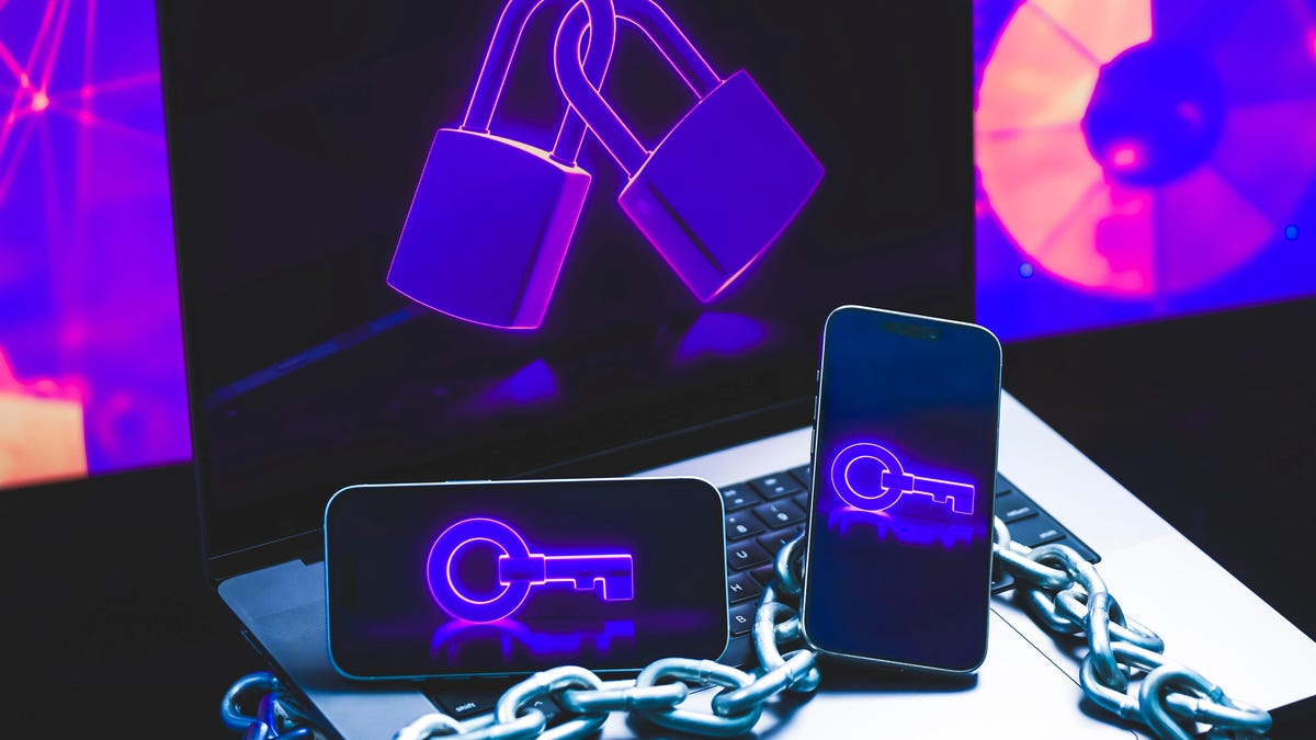 Keys and locks and chains on mobile phones and a laptop