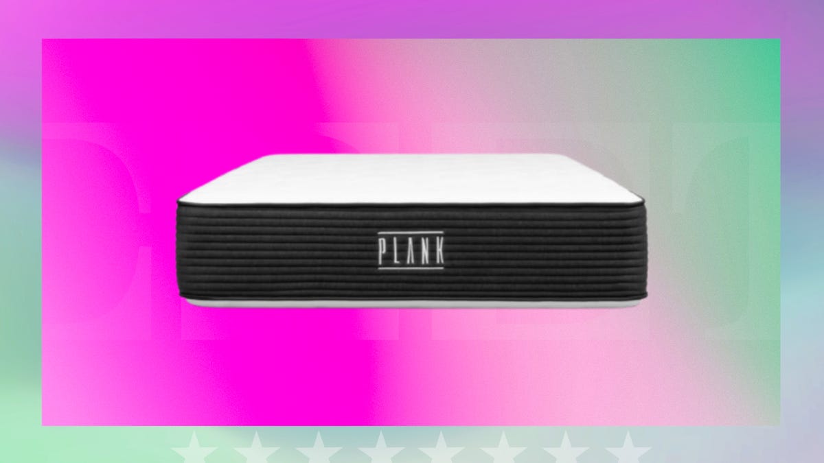 Black and white mattress with brand name Plank on the side displayed against a gradient pink and pale green background