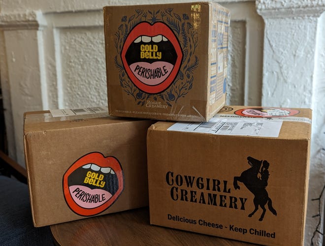 Three boxes of Goldbelly cheese stacked