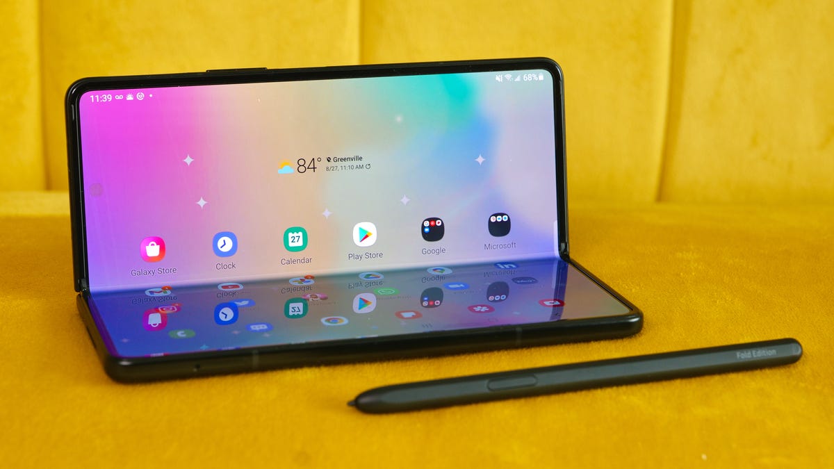 Galaxy Z Fold 3 open, next to its S Pen stylus