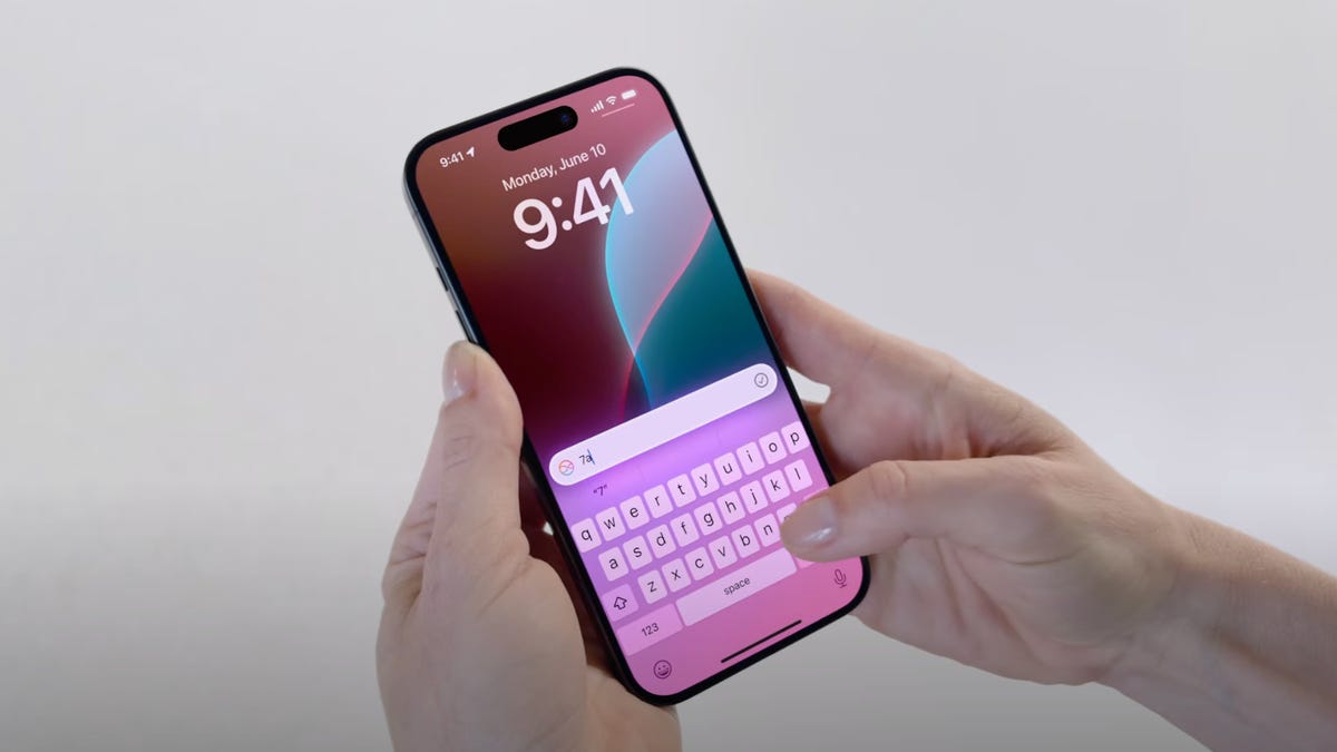 person typing on iphone using siri apple intelligence