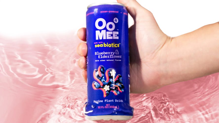The OoMee blueberry-elderflower drink in water with a light pink background.