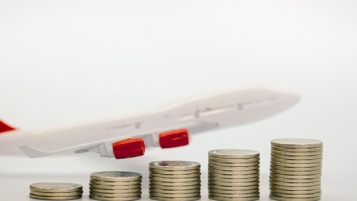 An airplane model above stacks of coins