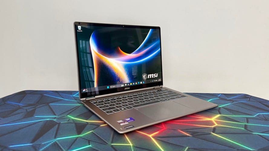 MSI Prestige 14 Flip AI Plus Panther Lake laptop at an angle on colorful desk mat