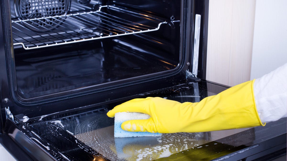A hand cleans oven