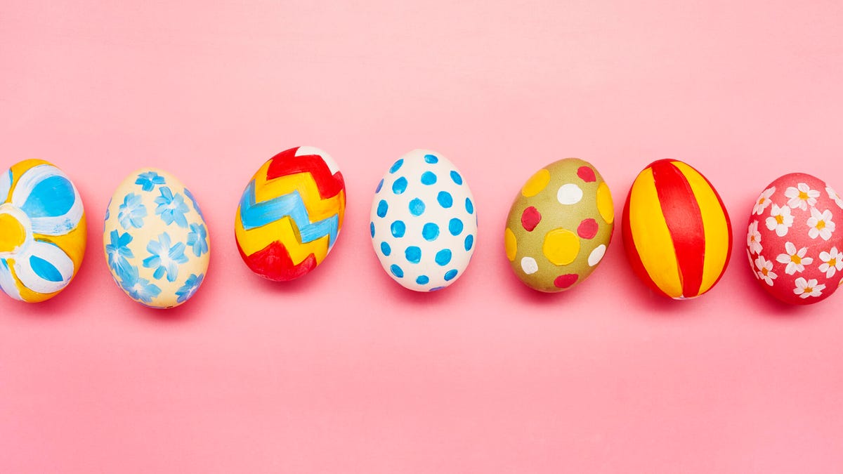 Directly above shot of colourful painted easter eggs on pink background