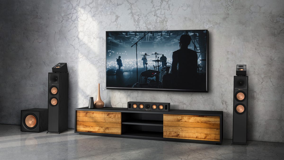 a Klipsch sound system and a TV showing a rock band