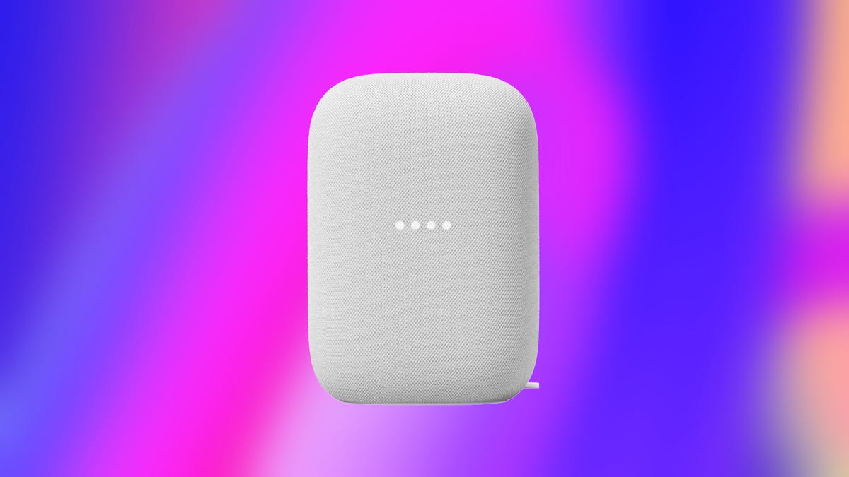 A white Google smart speaker against an abstract blue and pink background.