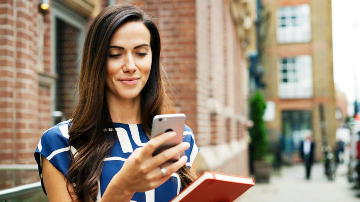 Woman holding phone and journal