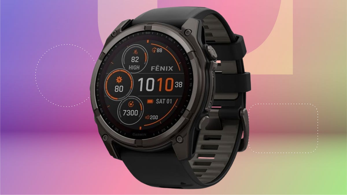 The Garmin Fenix 8 is shown against a multicolored background. The watch face features different dials for health tracking.