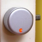 The August Wi-Fi Smart Lock installed in a white door.