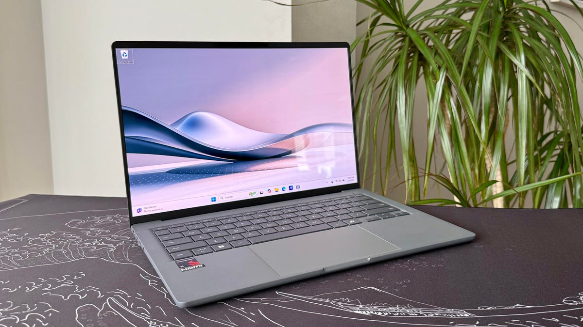 Asus Zenbook A14 Copilot Plus PC next to a house plant