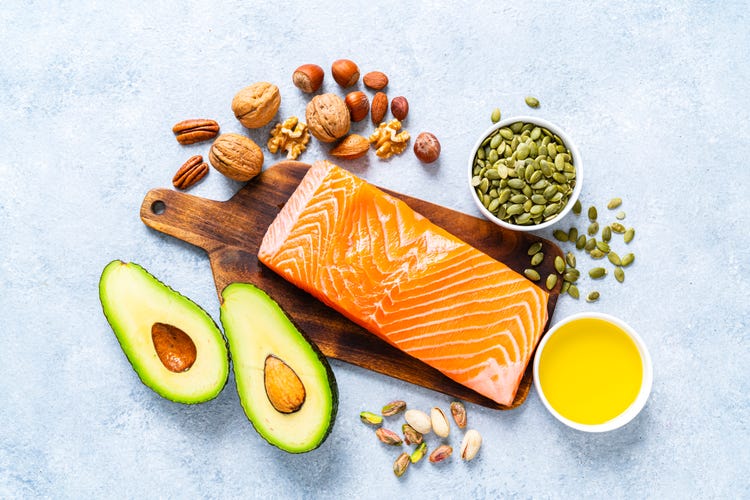 Salmon, avocado, nuts and more healthy fatty foods lined up 