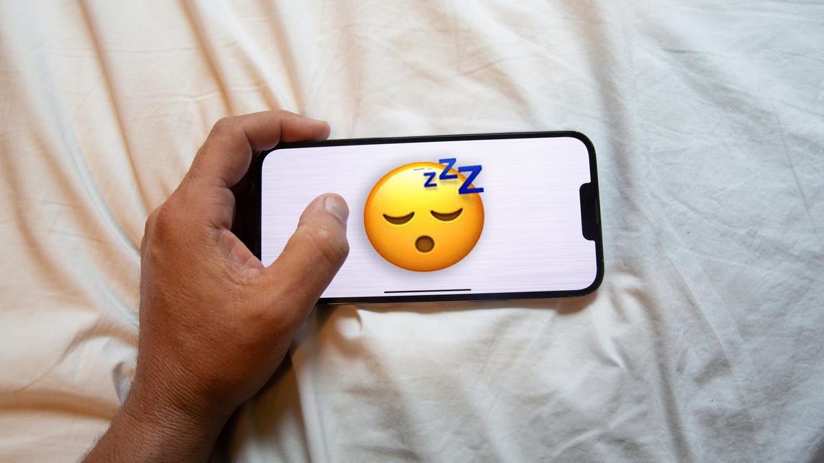The sleeping emoji on a phone in bed