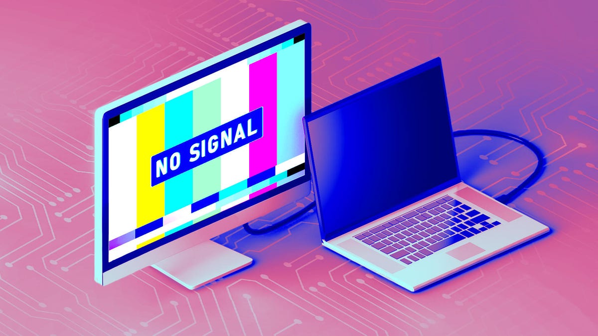 A laptop connected to a monitor with monitor displaying text that says "no signal"