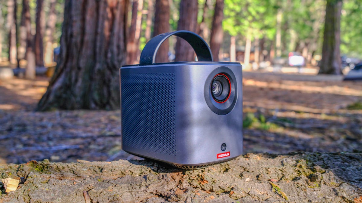 The Nebula Mars portable projector on a green gradient background