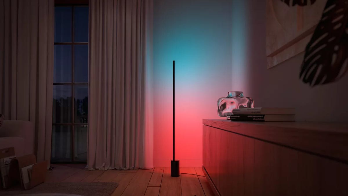 A smart floor lamp in the corner of a living room.