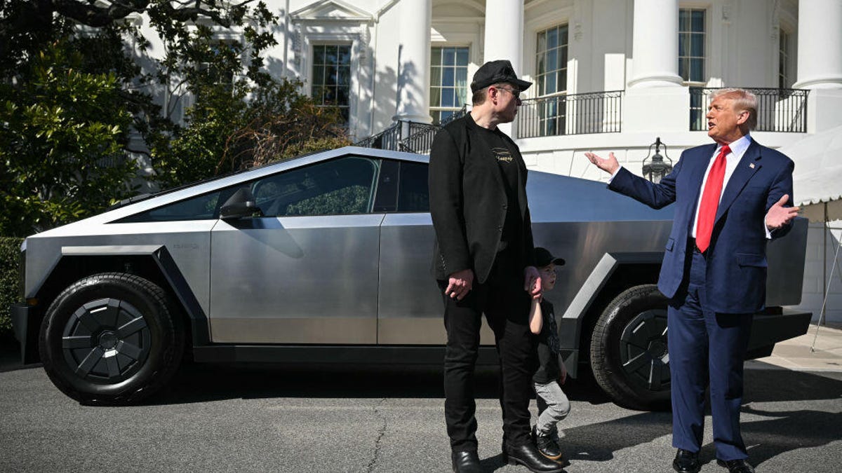 Elon Musk and Donald Trump stand next to a Tesla Cybertruck at the White House