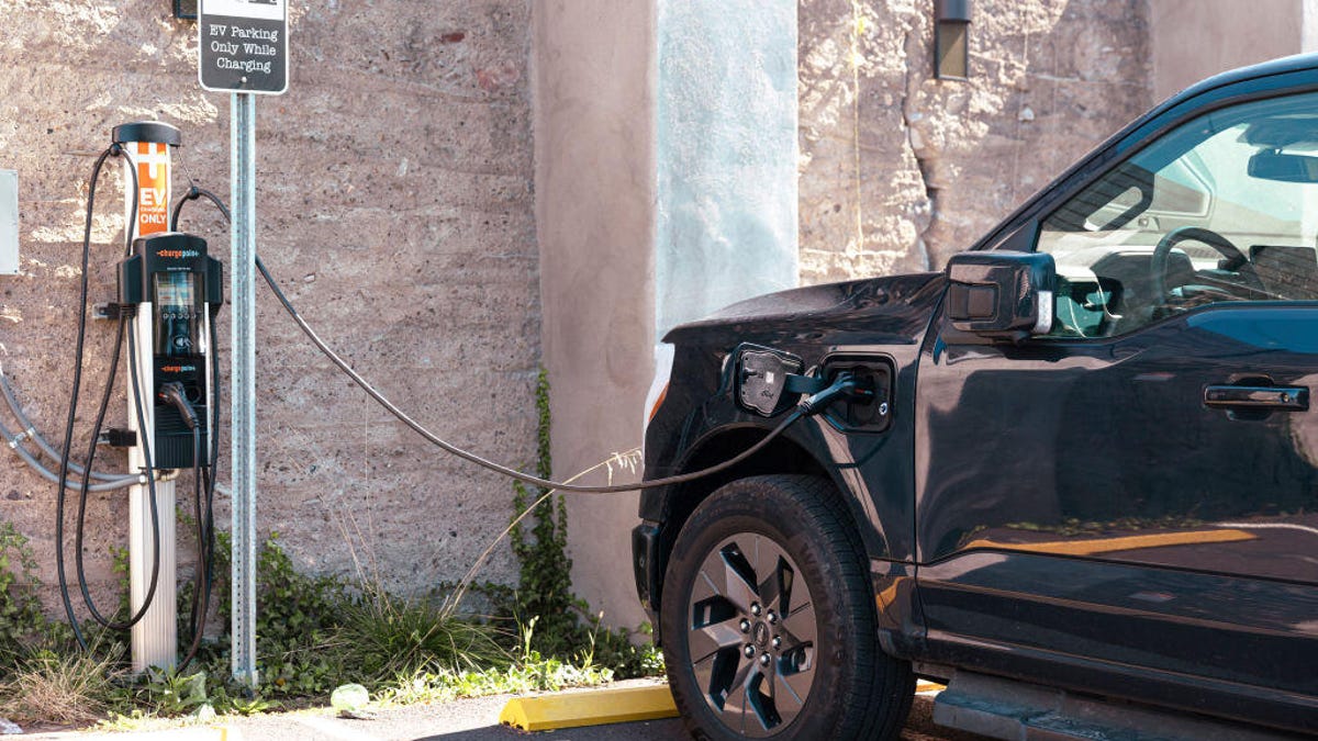 A Ford F-150 Lightning electric pickup truck charges at a ChargePoint electric vehicle charging station.