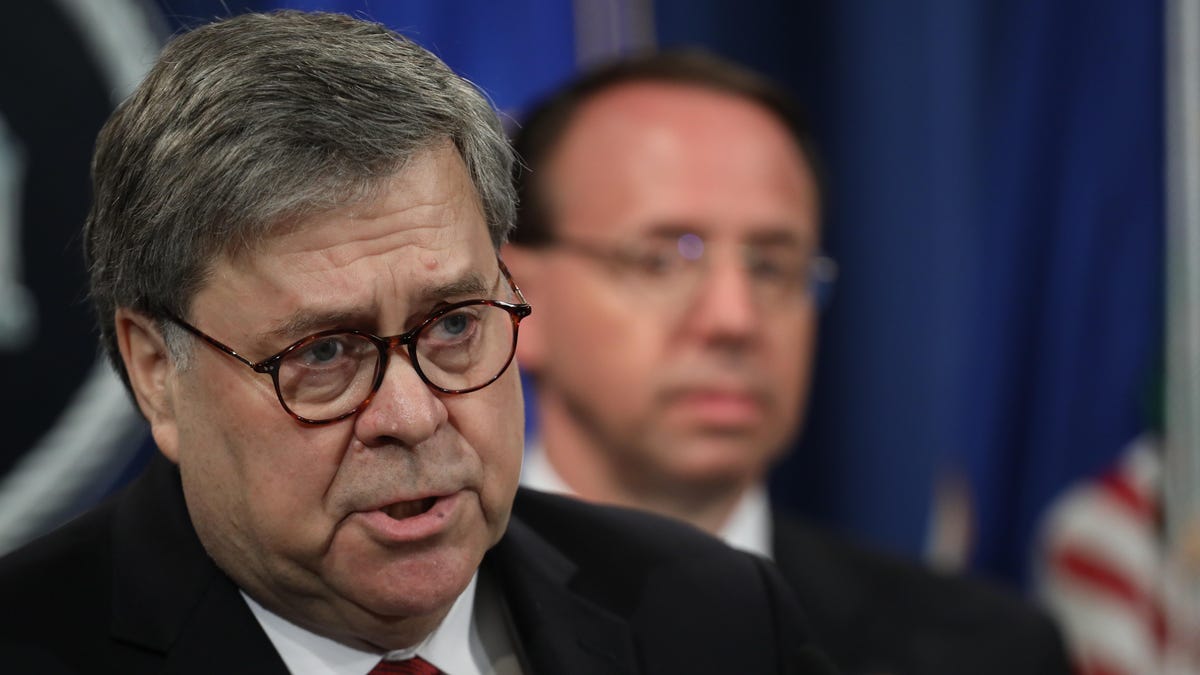 US Attorney General William Barr speaks Thursday about the release of the redacted version of the Mueller report as US Deputy Attorney General Rod Rosenstein listens.