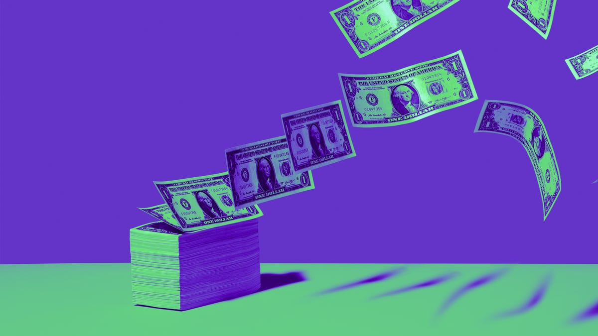 a stach of green dollar bills flying away one by one against a purple background