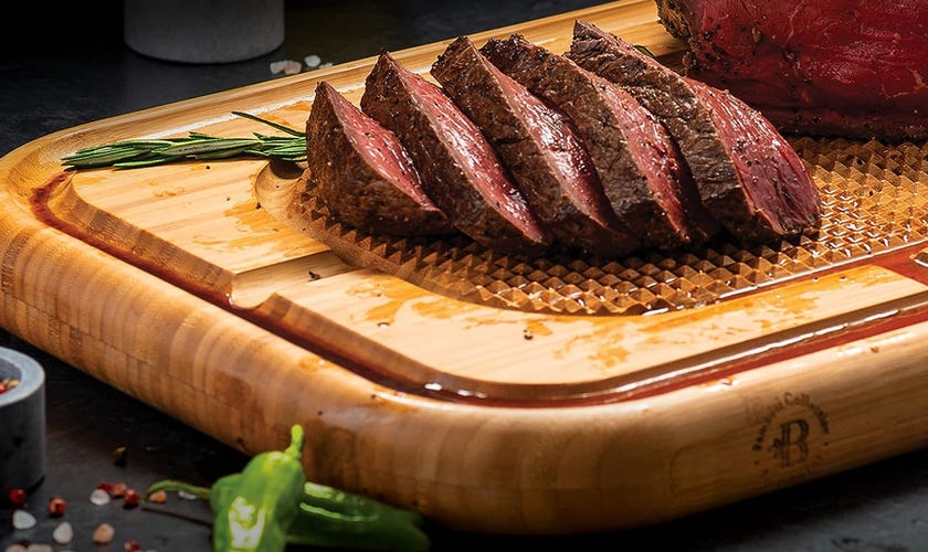 cutting board with meat on top