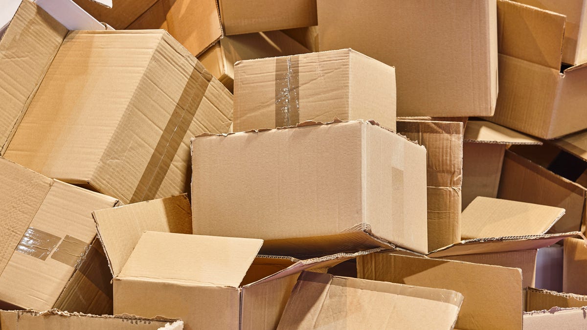 a big stack of medium-sized, used cardboard boxes, looking like they are waiting to be recycled