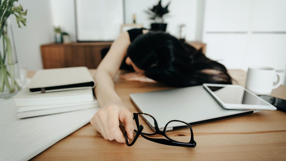woman stressed out sleeping at desk