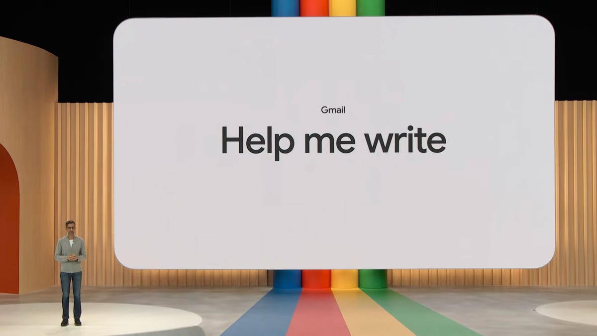 Google CEO Sundar Pichai in front of a giant white smartboard that says, "Help me write."