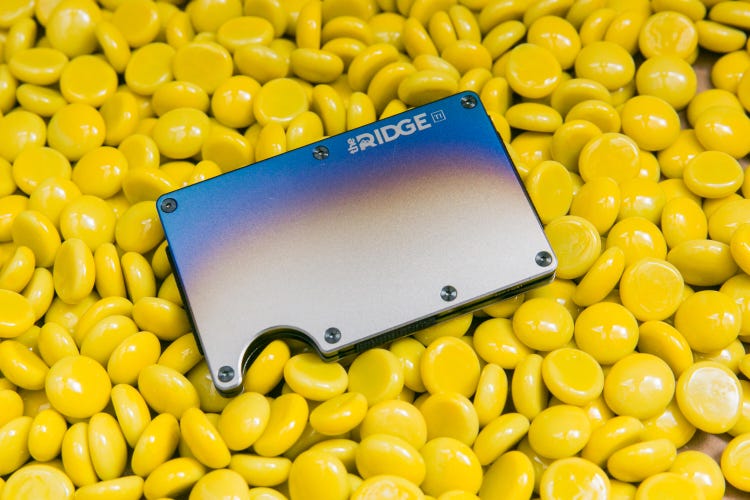 A luxury wallet by Ridge on a field of round yellow discs