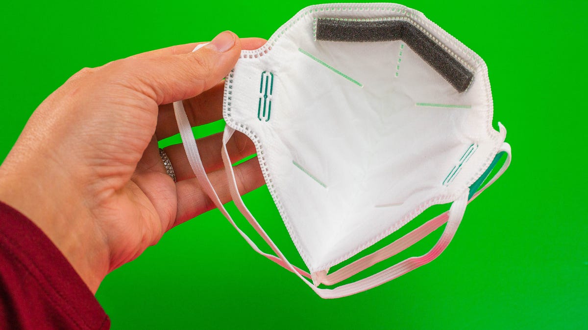 Hand holding an N95 mask