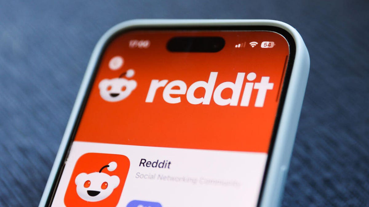 A phone is shown displaying the Reddit alien logo