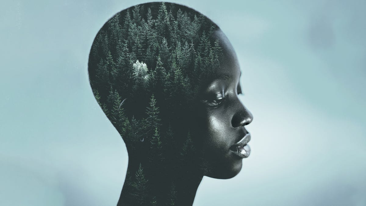 Somber woman with an image of a forest overlapping her mind.