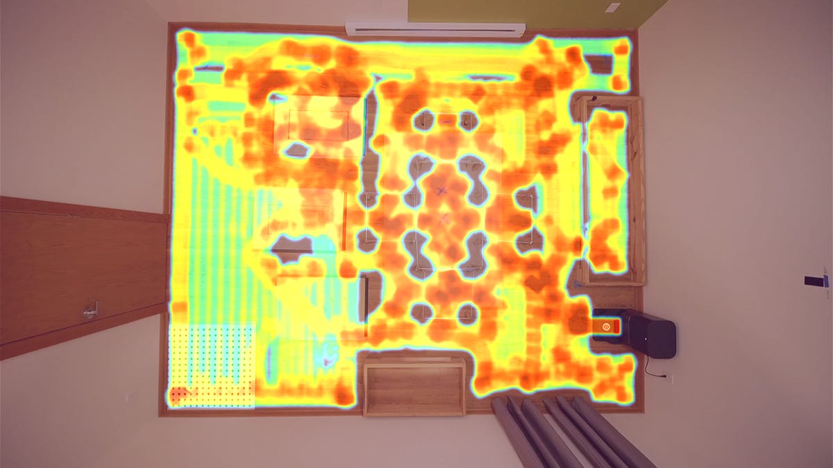 Dreame X50 vacuum next to a phone and watch along with badge with text: CNET Lab Test Winner 2025. Both devices show the D app.