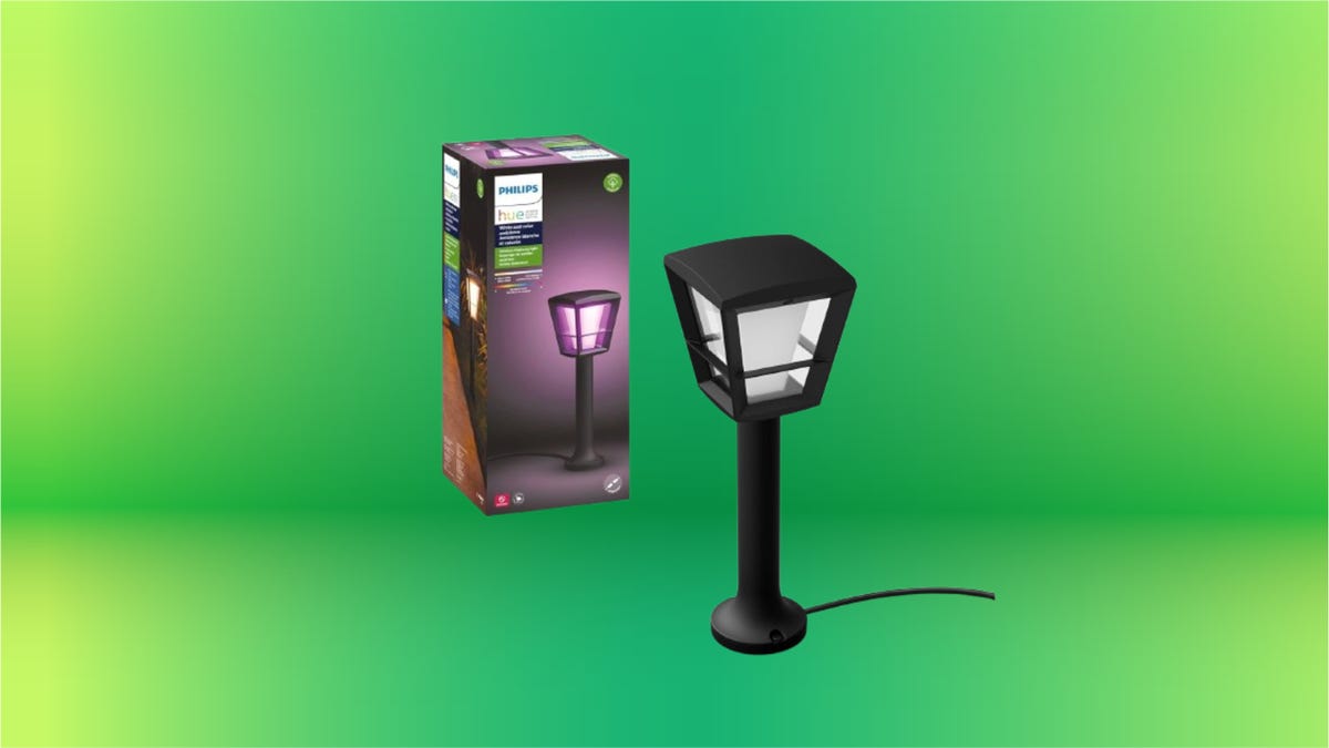 Purple box and outdoor light on stand against green background.
