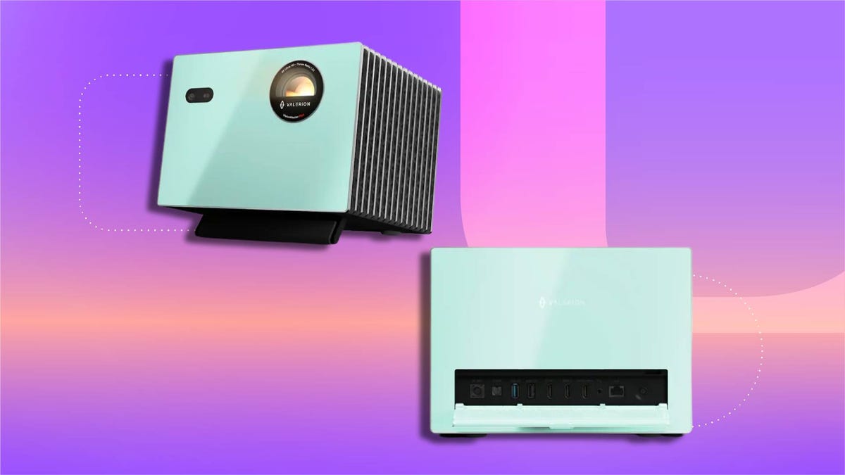 Mint-green Valerion projector shown from angled and top-down views -- front features circular lens and vented side panel; top view reveals control buttons and ports. Set against a gradient background in purple, pink and orange.