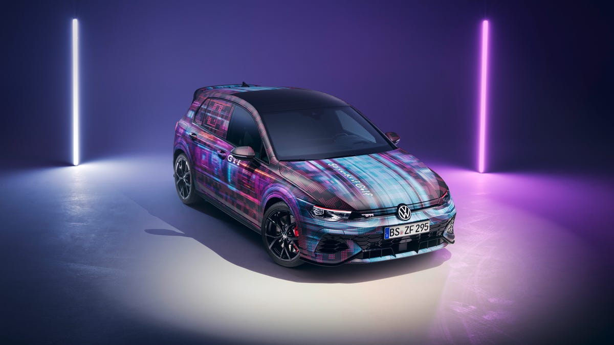 A multicolored VW Golf GTI car on a stage