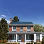 Solar panels on a two story house with a porch.