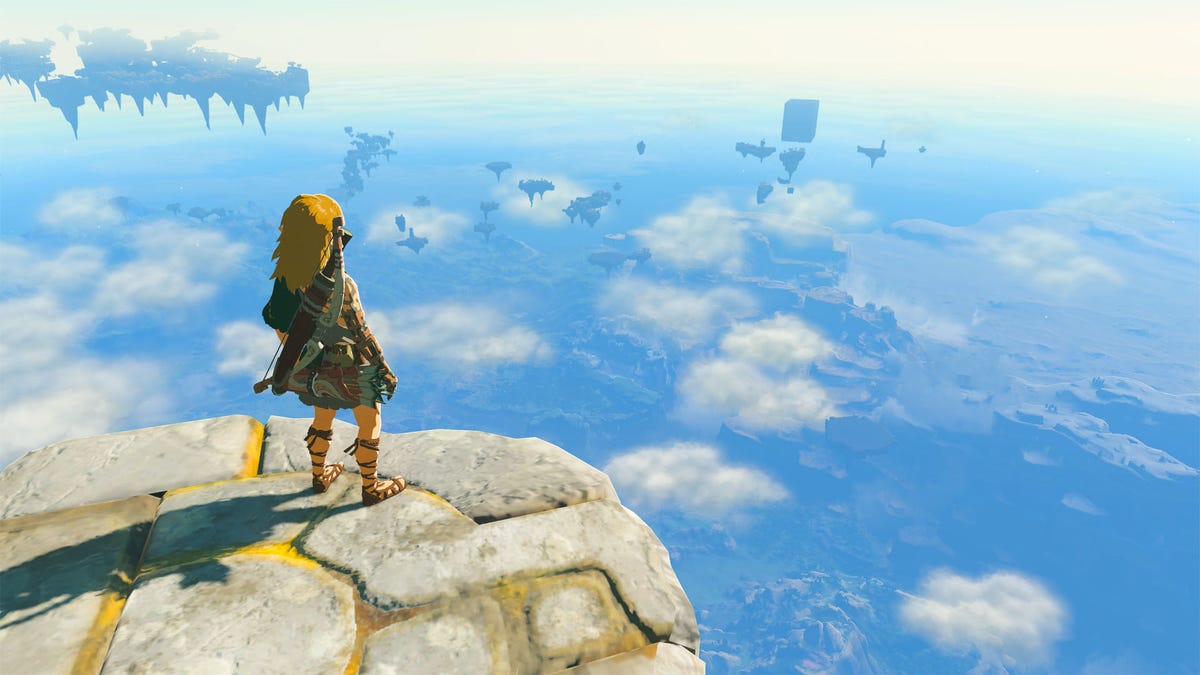 Link stands on a stone platform in the sky, looking out over the cloud-covered land in The Legend of Zelda: Tears of the Kingdom