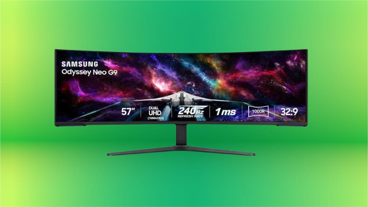 Black Samsung curved gaming monitor against green background.