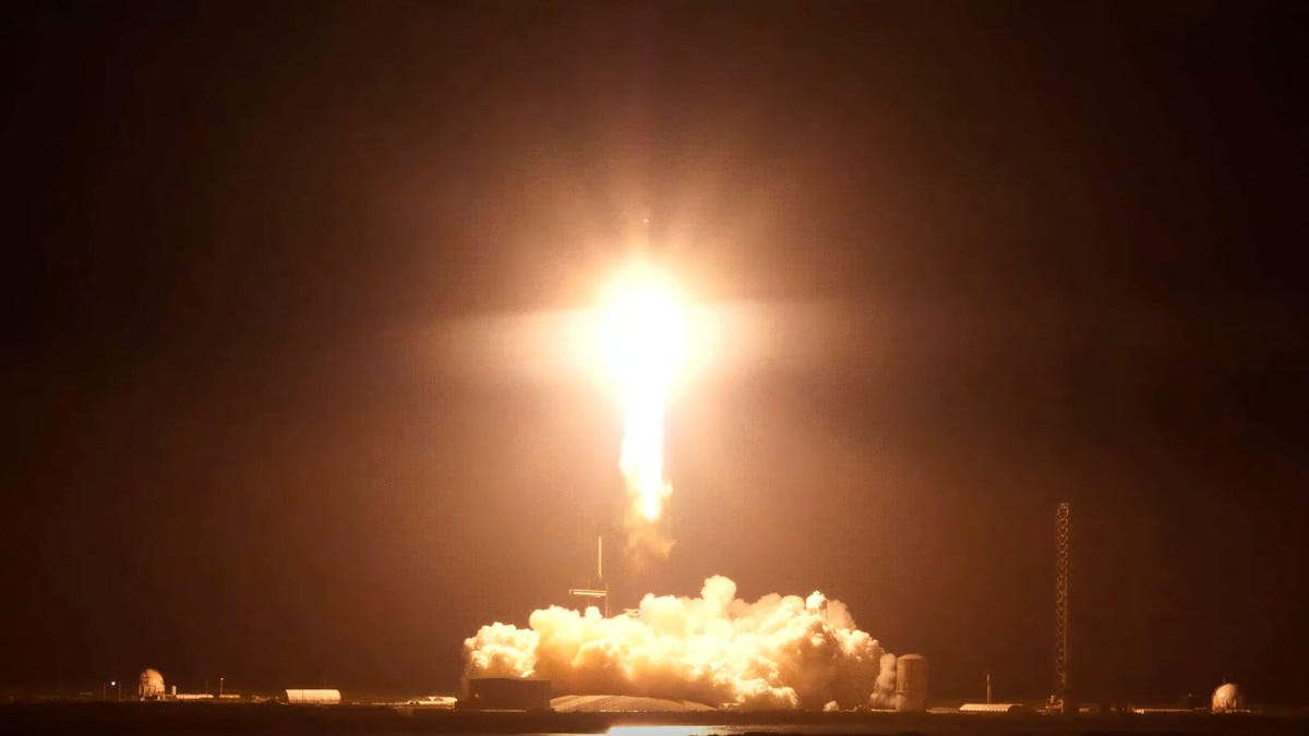 A SpaceX Falcon Heavy rocket launches Hughes Network Systems' Jupiter 3 satellite at night Florida