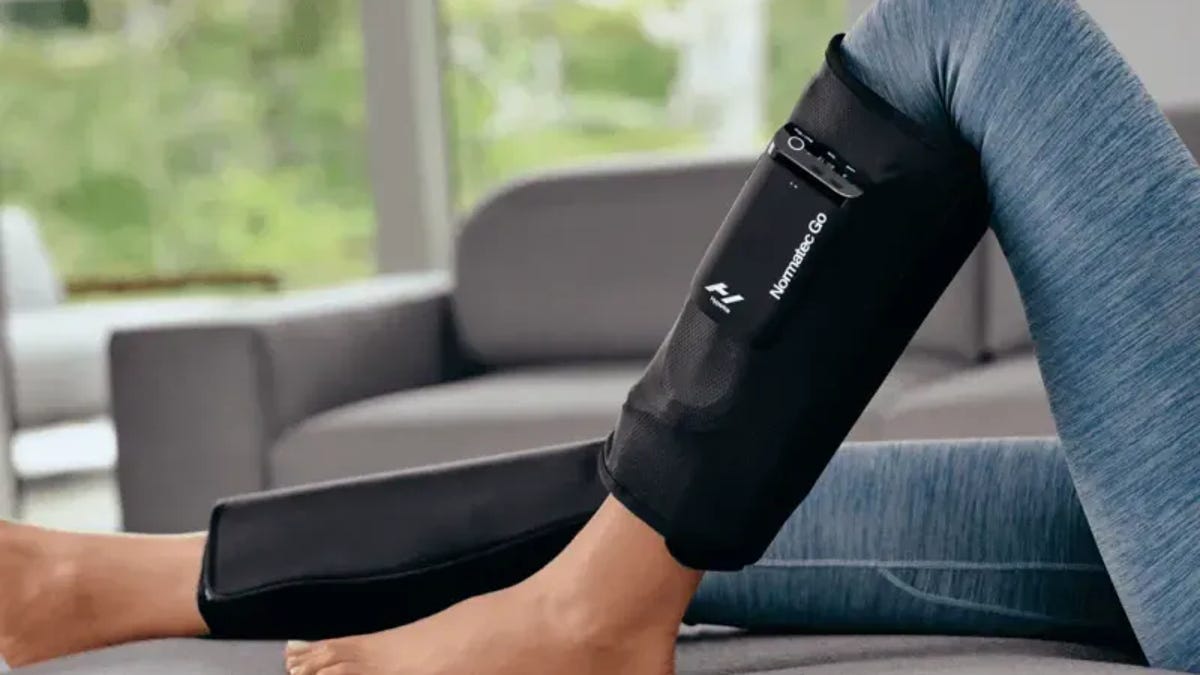 The Hyperice Normatec Go compression device around a woman's calves.