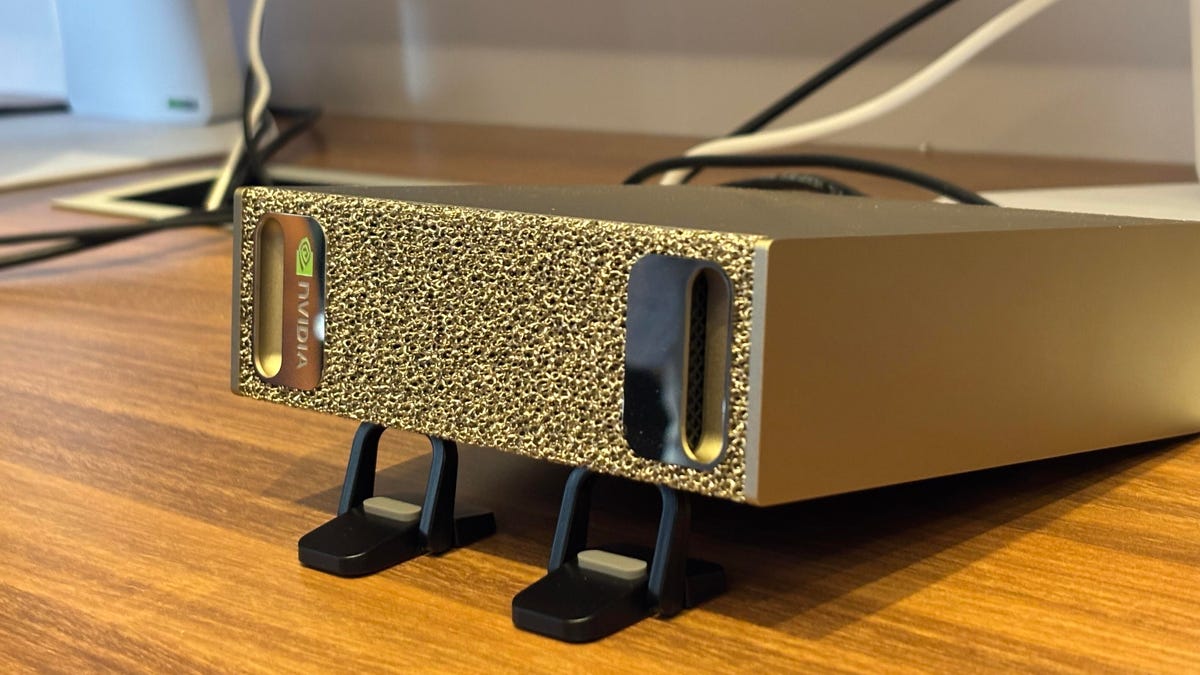 A small computer sits on a wooden table.