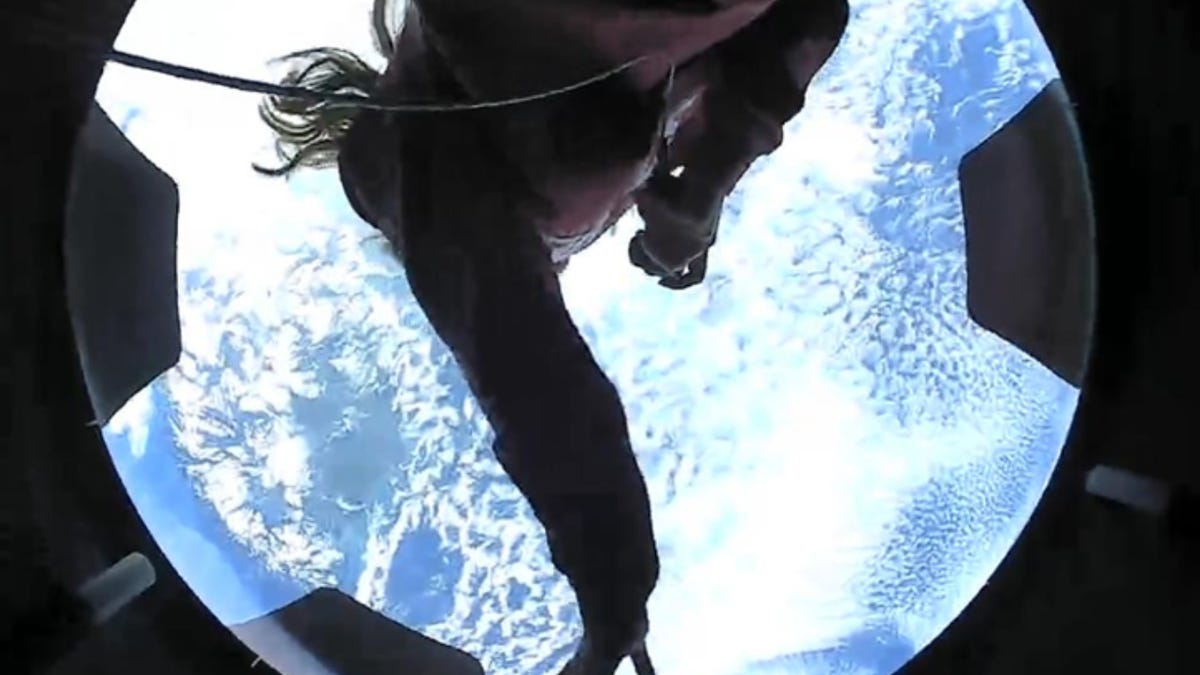 Hayley Arceneaux, medical specialist on the Inspiration4 mission, in the Crew Dragon cupola against a backdrop of the Earth
