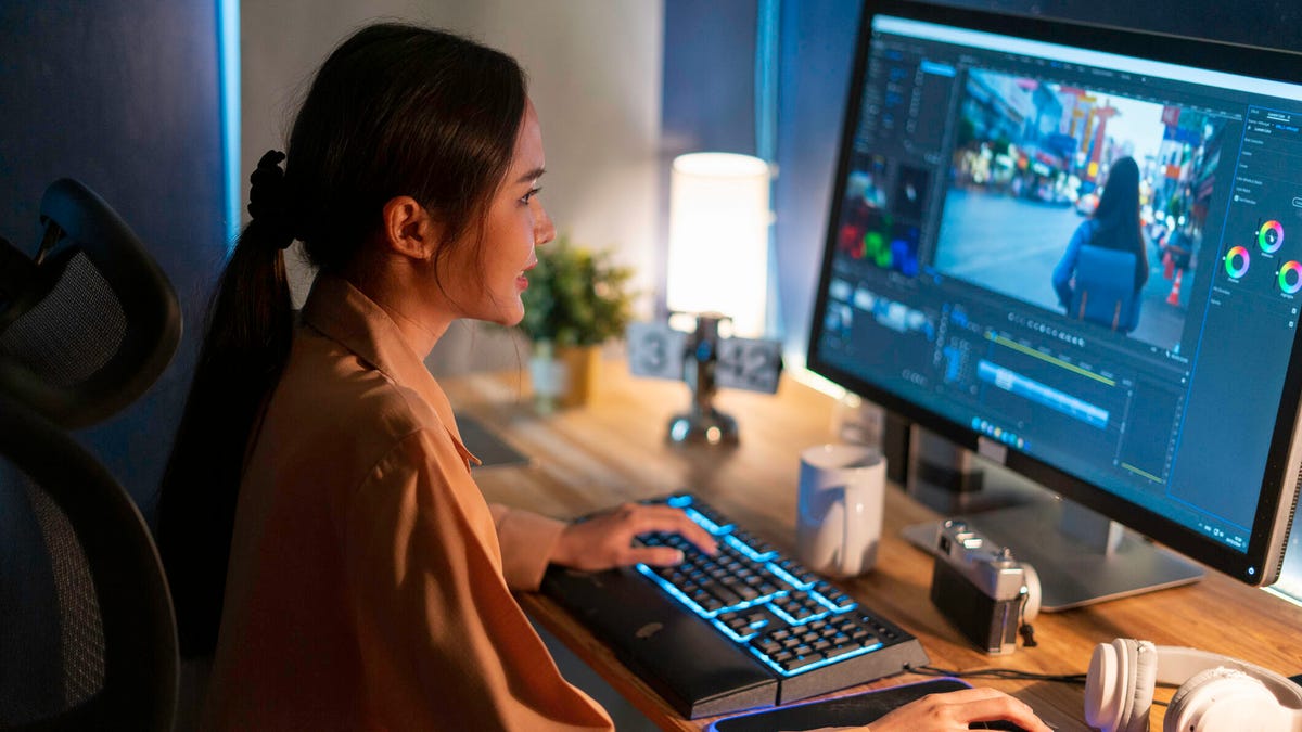 A photo of a woman editing a video on a desktop computer gettyimages-1437464445