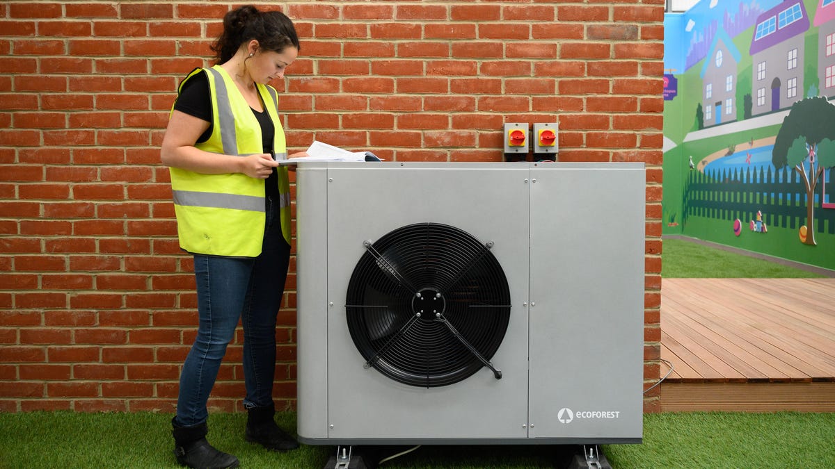 Technician working on an air conditioning heat pump