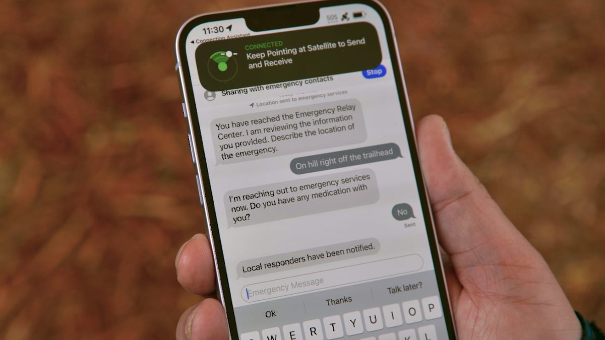 An iPhone 14 showing a text conversation with emergency dispatchers