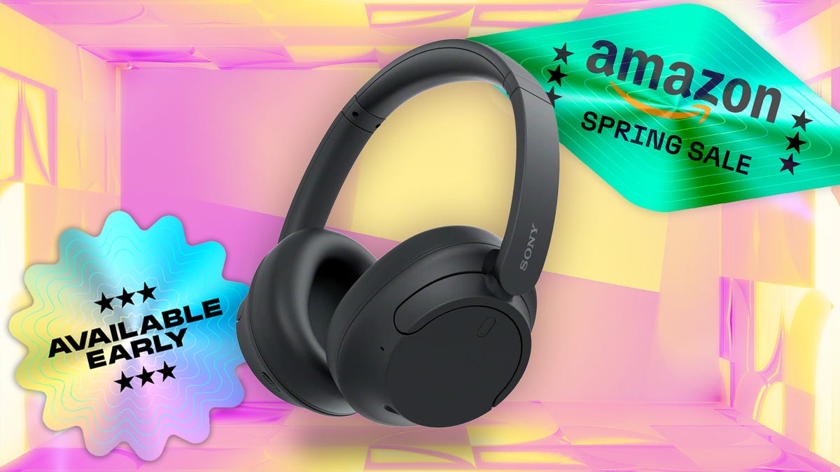 Black Sony wireless headphones against pink and yellow CNET background.