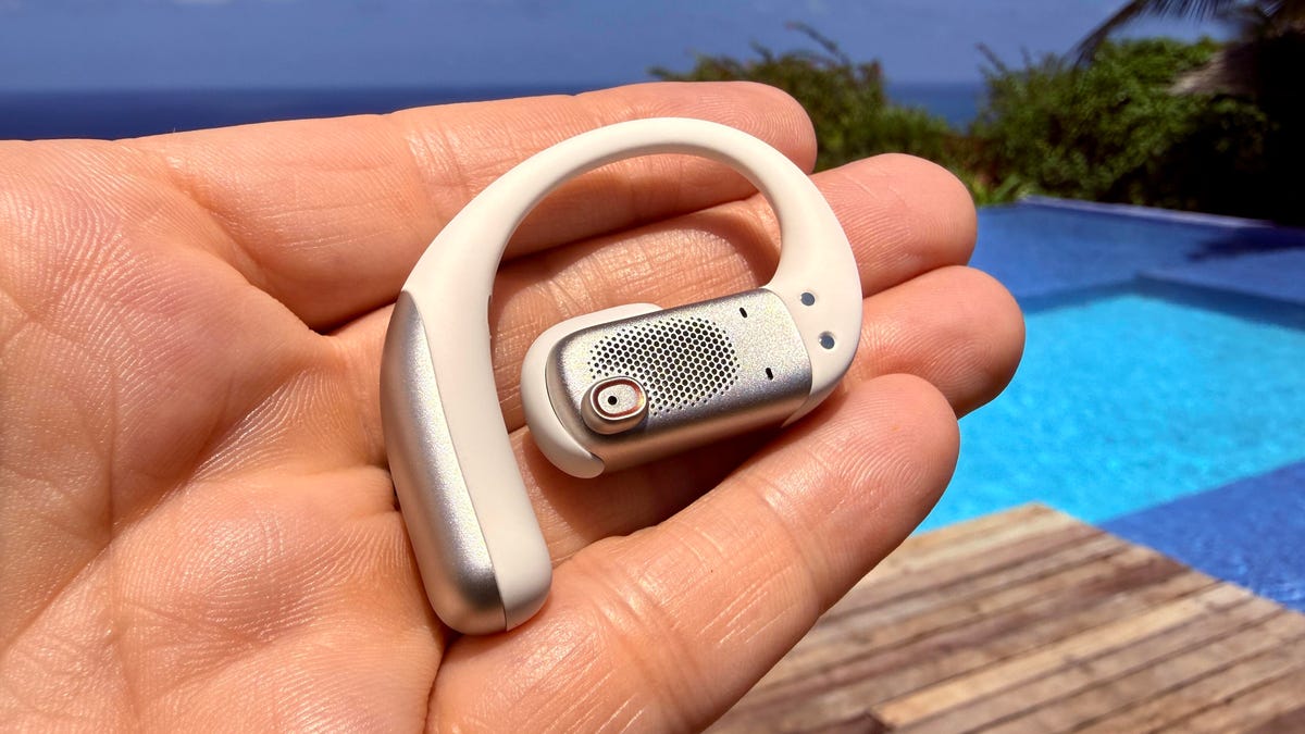 Shokz OpenFit Pro in hand showing the larger drivers