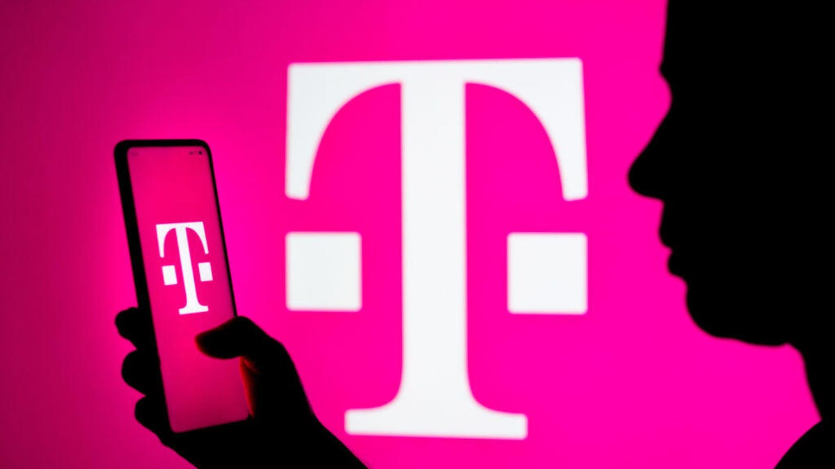 Woman looks at phone with T-Mobile logo on it